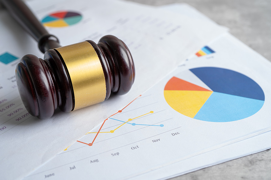 gavel over financial charts on a desk