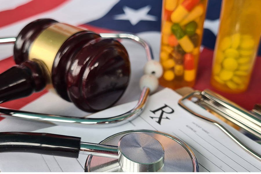 gavel on flag with prescription drug bottles
